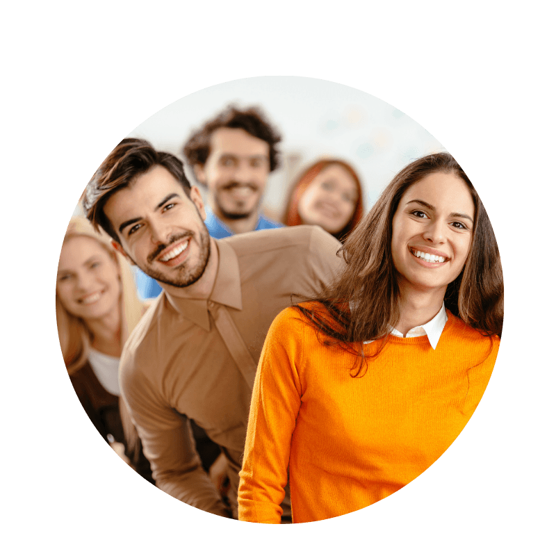 Mehrere junge Erwachsene stehen nebeneinander und lächeln – sie nehmen an einer Teamfortbildung teil.